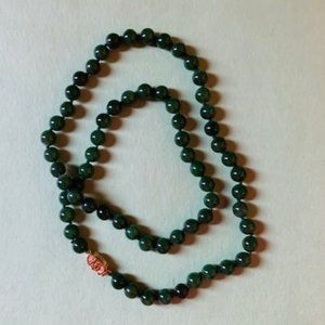 Jade bead necklace with gold color clasp